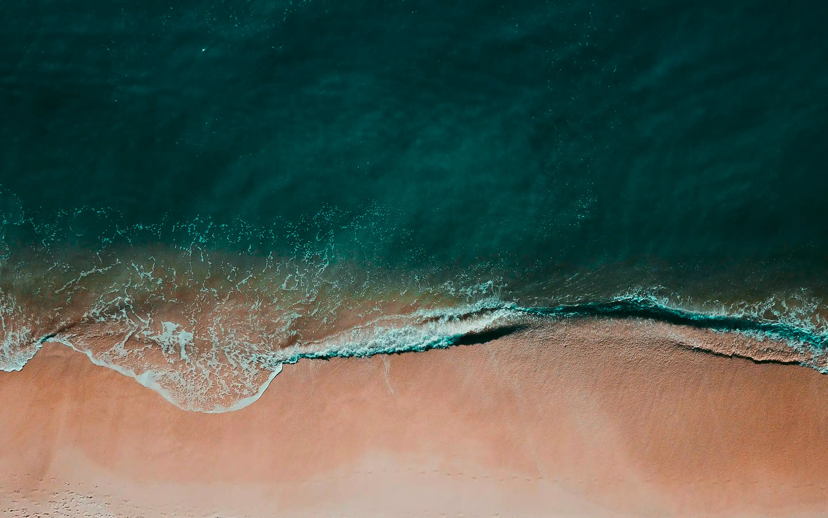 Aerial view of waves meeting the shore